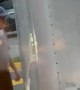 Wind Blows Loose Trailer in Parked Car
