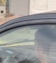 Woman Writing in a Notebook While Driving