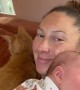 Cat Cuddles Up to Mom and Baby